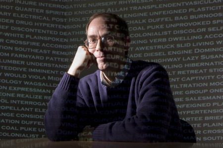an image of a man sitting at a table with a laptop