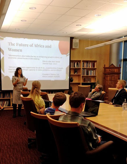 an image of a woman giving a presentation to a group of people