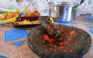 an image of a table with a bowl of food and a pan of food