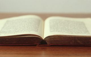 an image of a book open on a table with a white background