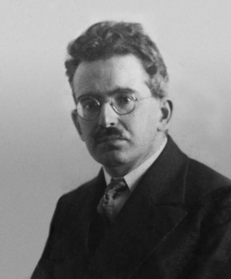 Portrai of Walter Benjamin, a well-dressed man with glasses and a small mustache